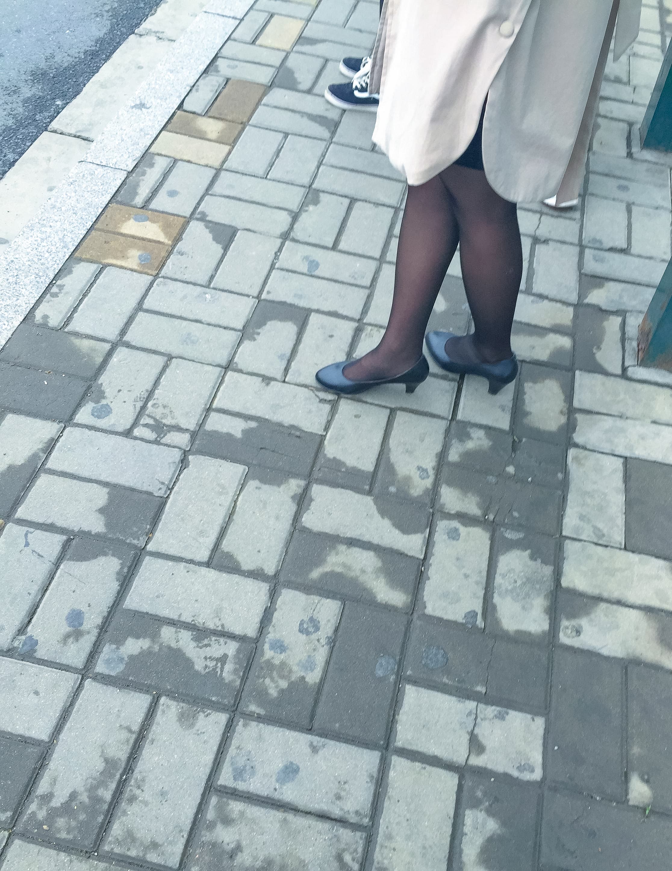 Woman in black pantyhose waiting